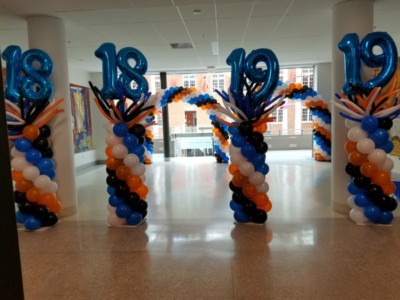 Balloon columns with numbers and wacky toppers